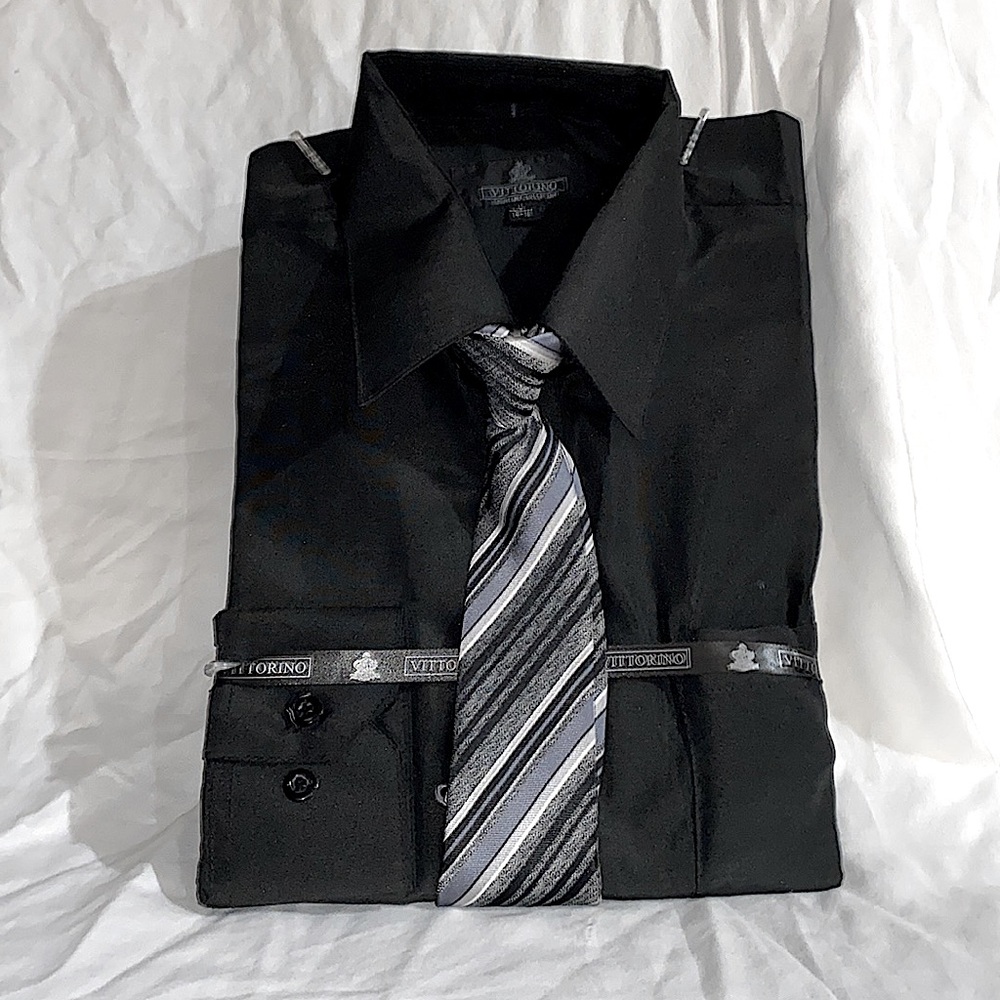 A black buttoned down shirt with sliver, grey, white and black tie